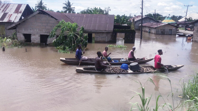 FILE - People transport cassava in a canoes along flooded residential streets after a heavy downpour In Bayelsa, Nigeria, Oct. 20, 2022. West and Central African countries are battling deadly floods that have upended lives and livelihoods, raising fears of further disruption of food supplies in many areas battling armed conflict. “Above-average rainfall and devastating flooding” have affected 5 million people this year in 19 countries across West and Central Africa, according to a new U.N. World Food Program situation report. (AP Photo/Reed Joshua, File)