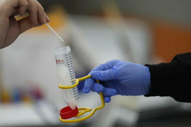 Passengers disembarking from international flights take anonymous COVID tests for study purposes at Newark Liberty International Airport in Newark, N.J., Wednesday, Jan. 4, 2023. Amid a COVID-19 surge in China, the U.S. is expanding its traveler-based genomic coronavirus surveillance program, an early warning system for detecting new variants. (AP Photo/Seth Wenig)