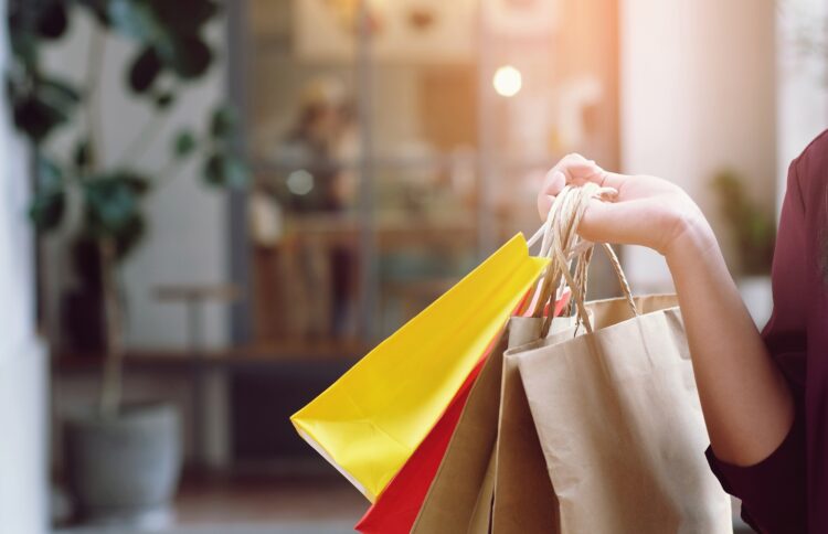 Sin Asian girls holding sale shopping bags.  consumerism lifestyle concept  in the shopping mall