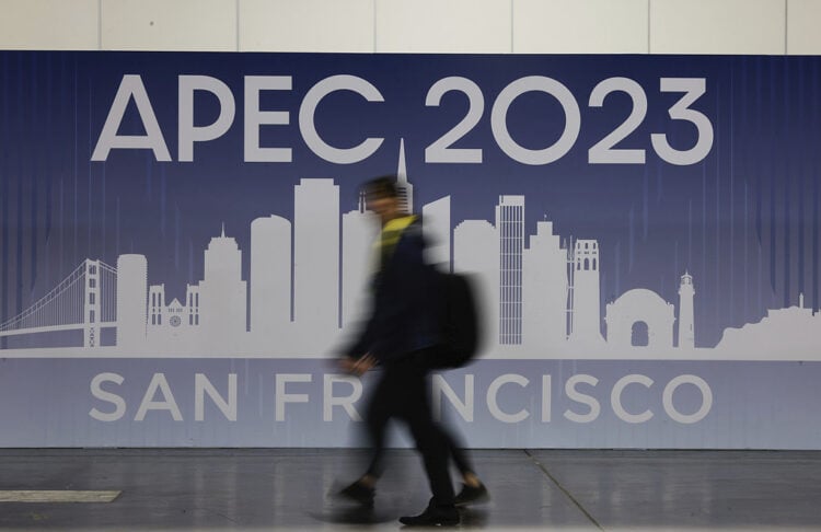 People walk past APEC Summit signage displayed at Moscone North on Monday, Nov. 13, 2023, in San Francisco. (Lea Suzuki/San Francisco Chronicle via AP)