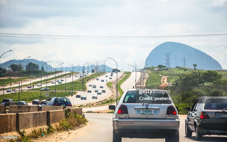 Abuja, Nigeria - September 6, 2015: Busy traffic scene on the new built wide highways in outskirts of Nigeria's capital city.