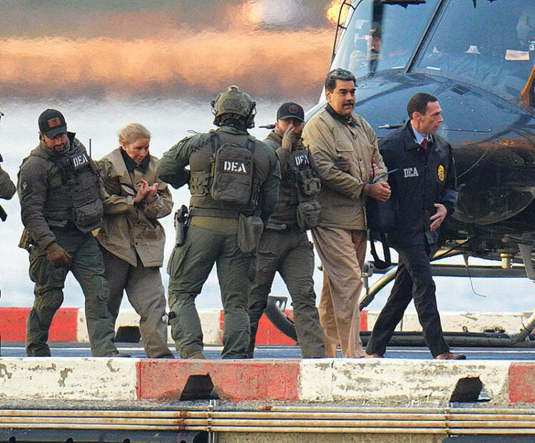 Photo by: XNY/STAR MAX/IPx 2026 1/5/26 Nicolas Maduro and his wife, Cilia Flores, are seen in handcuffs after landing at a Manhattan helipad, escorted by heavily armed Federal agents as they make their way into an armored car en route to a Federal courthouse in Manhattan on January 5, 2026 in New York City.