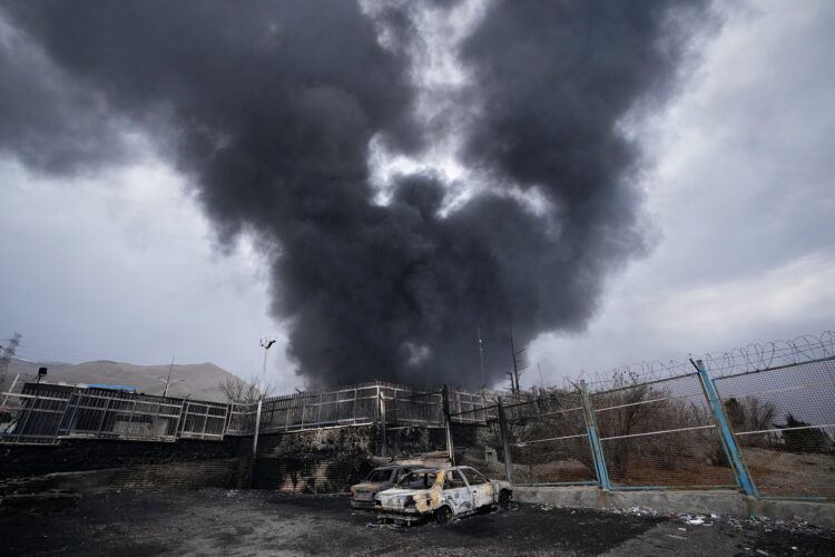 A thick plume of smoke rises from an oil storage facility hit by a U.S.-Israeli strike late Saturday in Tehran, Iran, Sunday, March 8, 2026. (AP Photo/Vahid Salemi)