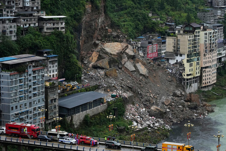 Chongqing Rescuers stand by along the bridge as they prepare to conduct a search and rescue operation at the scene of a landslide in Pengshui County in southwestern China's Chongqing on Saturday, July 18, 2026. (AP Photo/Andy Wong)